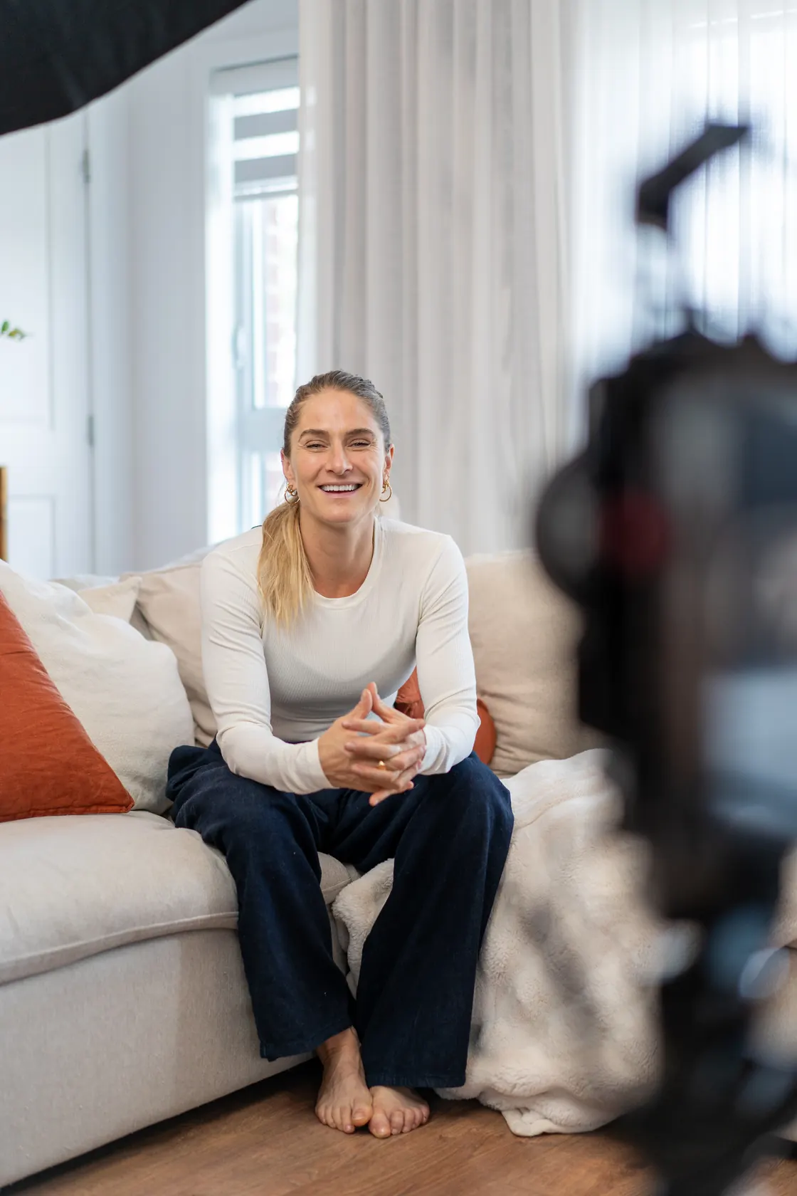 Natasia Schumacher on set during her content session, camera in the foreground